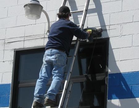 Photo of an employee performing commerical building repairs